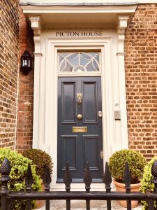 Front door behind iron railings